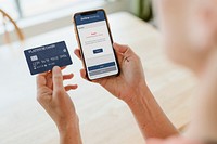 Woman having trouble processing her credit card via a mobile phone mockup during the coronavirus pandemic