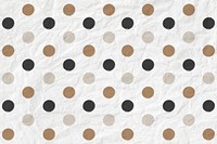 Polka dot pattern vector in black and gold on crumpled paper textured background