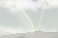 Rainbow over mountains background psd with clouds