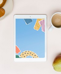 Tablet screen with ripped paper collage wallpaper flat lay