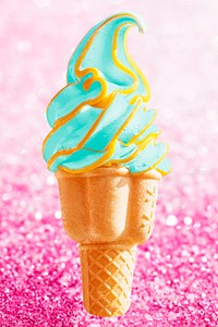 Green soft serve ice cream in a cone on pink glitter background