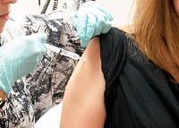 A woman receiving a dose of the investigational NIAID/GlaxoSmithKline (GSK) Ebola vaccine. Original image sourced from US Government department: Public Health Image Library, <a href="https://www.rawpixel.com/search/cdc?sort=curated&amp;page=1">Centers for Disease Control and Prevention</a>. Under US law this image is copyright free, please credit the government department whenever you can&rdquo;.