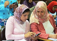 Egyptian women comparing their scientific findings during a meeting of the newly formed Eastern Mediterranean Acute Respiratory Infection Surveillance (EMARIS) Network, a regional network for standardized, and enhanced surveillance of severe acute respiratory illness, particularly influenza, in the Eastern Mediterranean Region.