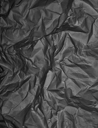 Crumpled black garbage bag texture background