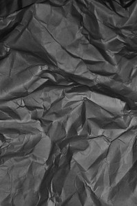 Crumpled black garbage bag texture background
