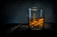 Free whiskey glass with ice cute in dark background 