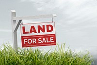 Real estate background, land for sale sign on grass