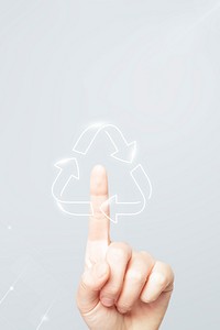 Sustainable technology, gray background, hand pressing recycle symbol