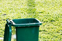 Opened recycling bin in the grass field earth day campaign