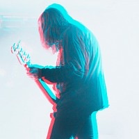 Bassist performing in a concert in double color exposure effect