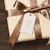 Present greeting tag mockup psd on a gift box with be happy and smile text