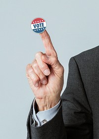 Businessman with a vote sticker on his index finger 