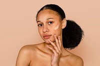 Woman applying foundation on tanned skin, makeup & cosmetics