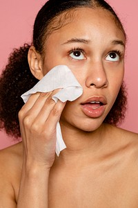 Woman using makeup remover wet tissue 