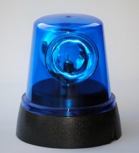 A blue flashing light. Original public domain image from <a href="https://commons.wikimedia.org/wiki/File:Rundumkennleuchte_blau.jpg" target="_blank" rel="noopener noreferrer nofollow">Wikimedia Commons</a>