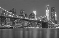 Black and white photo of the Brooklyn Bridge with the Manhattan skyline in the distance. Original public domain image from Wikimedia Commons