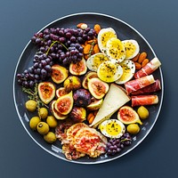 Snack platter on dark blue background, food photography