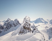 A mountainscape background photo capturing snowy hills and rock formations. Original public domain image from <a href="https://commons.wikimedia.org/wiki/File:Winter_in_the_wilderness_(Unsplash).png" target="_blank" rel="noopener noreferrer nofollow">Wikimedia Commons</a>