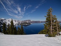 Crystal-clear Crater Lake in Klamath County, Oregon.  Rather than the typical lake fed by incoming streams and thus occluded by silt and pollution, this is a 1,900-foot-deep caldera formed 7,700 years ago when a massive volcano collapsed.  Its waters, collected from rainfall and snowmelt in this high country, are said to be purer than filtered tapwater.