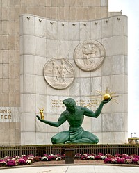 The Spirit of Detroit, a city monument with a large bronze statue at the Coleman A. Young Municipal Center in Detroit, Michigan, at the downtown beginning of one of the longest streets in the world — Woodward Avenue — which stretches northward an amazing 27 miles to the city of Pontiac.