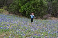 Kyndal Britt Peevey of Leander, Texas, skips through a field of bluebonnets near Inks Lake in the Texas Hill Country.