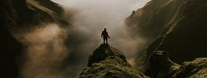 Man standing on a misty cliff banner