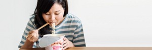 Asian woman eating instant noodles during coronavirus quarantine banner
