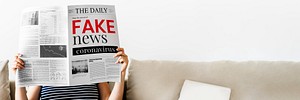 Woman reading fake coronavirus news from a newspaper during coronavirus quarantine