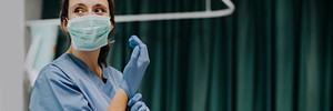 Beautiful female doctor wearing medical gloves