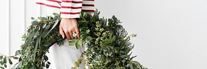 Woman carrying a fresh Christmas wreath social template