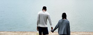 Couple holding hands by the lake