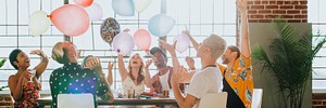People playing with balloons at a party landscape banner