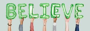 Hands holding believe word in balloon letters