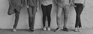 Cropped people standing in a row legs