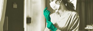 Doctor putting on a glove to prevent coronavirus contamination
