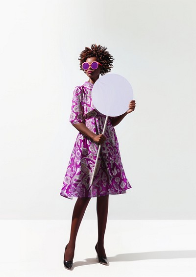 Woman holding giant sign photography fashion dress.