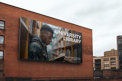 Student reading university library billboard