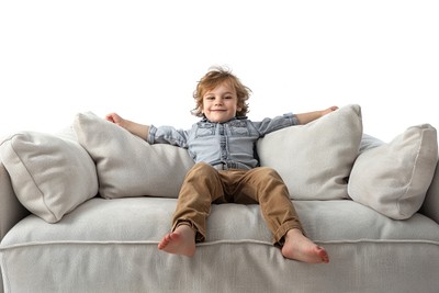 Happy child relaxing on sofa