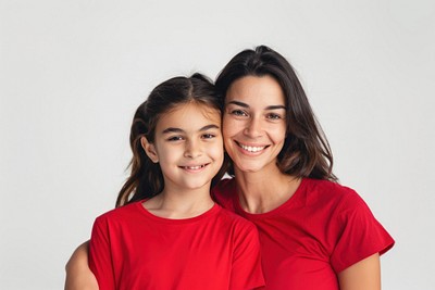 Mother daughter red shirts smiling