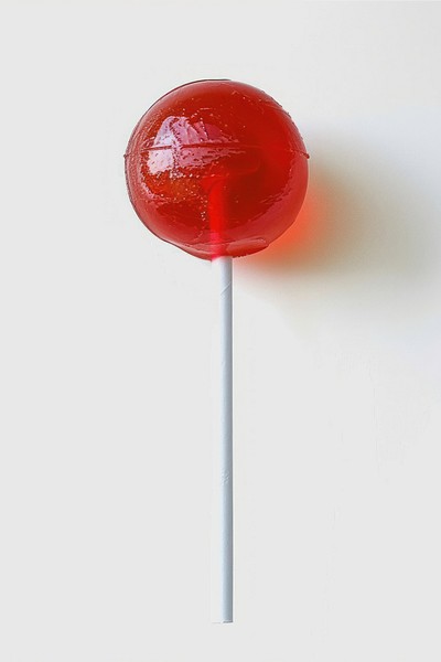 Red lollipop on white background