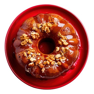 A rich golden-brown rum cake with a glossy glaze and sprinkles of walnuts on top confectionery ketchup sweets.