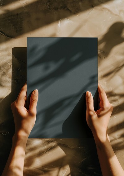 Hands holding dark paper shadows