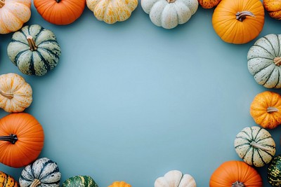 Autumn pastel background with pumpkins and gourds on a blue table decoration halloween autumn.