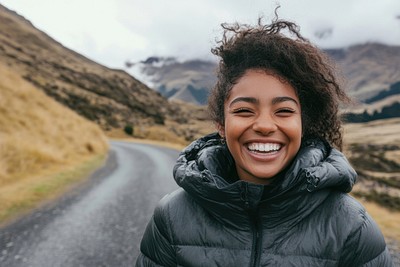 Happy young woman wearing a down jacket laughing clothing apparel.