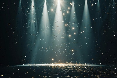 A background with spotlights shining down lighting confetti backdrop.