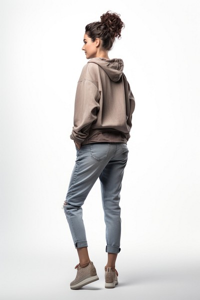 A old woman in jeans looking up on a white background isolation back view sweatshirt sleeve denim.