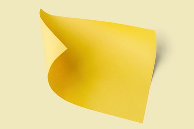 Premium Photo  Yellow sticky paper with button, curled on a white
