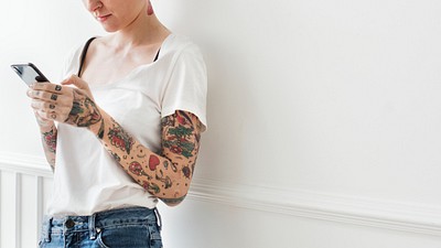 Tattooed woman using her phone | Premium Photo - rawpixel