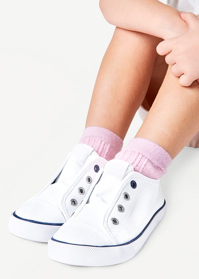 Girl with white sneakers studio shot