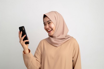 Happy Asian Muslim adult photo phone. 